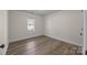 Simple bedroom with wood-look floors and neutral wall color at 1417 Wildwood Dr, Kannapolis, NC 28081