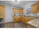 L shaped kitchen with light wood cabinets, stainless steel appliances, and vinyl flooring at 1417 Wildwood Dr, Kannapolis, NC 28081