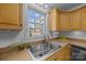 Kitchen sink and counter with light wood cabinets and stainless steel dishwasher at 1417 Wildwood Dr, Kannapolis, NC 28081