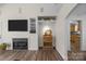 Living room with fireplace, built-in shelving, and view of kitchen at 1417 Wildwood Dr, Kannapolis, NC 28081