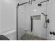 Modern shower with subway tile and pebble floor at 1417 Wildwood Dr, Kannapolis, NC 28081