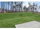 Grass backyard with patio and treeline at 146 Dogwood Grove Pl, Troutman, NC 28166