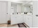 Double vanity bathroom with white cabinets and a large mirror at 146 Dogwood Grove Pl, Troutman, NC 28166