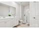 Bright bathroom with a double sink vanity and a glass enclosed shower at 146 Dogwood Grove Pl, Troutman, NC 28166