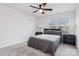 Cozy bedroom with carpet, ceiling fan, window and black furnishings at 146 Dogwood Grove Pl, Troutman, NC 28166