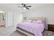 King bedroom with light purple bedding and carpet flooring at 146 Dogwood Grove Pl, Troutman, NC 28166