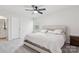 Bright bedroom with carpeted floor, ceiling fan, and large bed at 146 Dogwood Grove Pl, Troutman, NC 28166