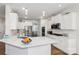 Modern kitchen with white cabinets, stainless steel appliances, and large island at 146 Dogwood Grove Pl, Troutman, NC 28166