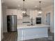 Modern kitchen with white shaker cabinets, quartz countertops, and stainless steel appliances at 1933 Hendricks St, Rock Hill, SC 29732