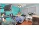 Bedroom with full bed, mounted TV, and teal walls at 2465 Cedar Valley Dr, Conover, NC 28613