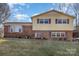 Brick and yellow-sided two-story house with a well-maintained lawn at 2465 Cedar Valley Dr, Conover, NC 28613