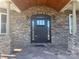 Elegant arched stone entryway with a black door at 250 Bost Rd, China Grove, NC 28023