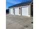 Three-car garage with white doors and large concrete driveway at 250 Bost Rd, China Grove, NC 28023