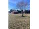 Rustic red shed and mature tree in a grassy yard at 250 Bost Rd, China Grove, NC 28023