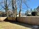 Yard with city skyline view beyond wooden fence at 2514 Ringwood St, Charlotte, NC 28208