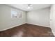 Simple bedroom with wood floors and two windows at 2514 Ringwood St, Charlotte, NC 28208