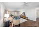 Living room featuring hardwood floors, neutral decor, and a ceiling fan at 2514 Ringwood St, Charlotte, NC 28208