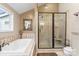 Spa-like bathroom featuring a soaking tub, walk-in shower, and tile flooring at 2633 Jb Denton Rd, Lancaster, SC 29720