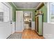 Entryway with green walls, white door, and view into kitchen at 2633 Jb Denton Rd, Lancaster, SC 29720