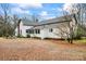 White farmhouse with gravel driveway and mature trees at 2633 Jb Denton Rd, Lancaster, SC 29720