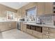 Spacious kitchen with light taupe cabinets, stainless steel appliances, and tile backsplash at 2633 Jb Denton Rd, Lancaster, SC 29720