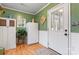 Laundry room with white refrigerator, green walls, and white door at 2633 Jb Denton Rd, Lancaster, SC 29720