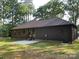 Exterior shot of backyard featuring a covered patio and a spacious green yard with direct door and window access at 305 General As Johnston St, Stanley, NC 28164