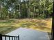 Expansive backyard featuring a newly installed patio, surrounded by lush greenery and mature trees at 305 General As Johnston St, Stanley, NC 28164