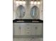 Bathroom featuring double vanity with black countertop, white cabinets, gold hardware, and framed mirrors at 305 General As Johnston St, Stanley, NC 28164
