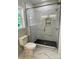 Bathroom showcasing black and white marble tiling in the shower, contrasting with dark shower floor tiles at 305 General As Johnston St, Stanley, NC 28164