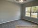 Simple bedroom with grey walls, carpet, and a large window at 305 General As Johnston St, Stanley, NC 28164