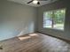 Bedroom with wood flooring, ceiling fan, natural light, and a view of the outdoors at 305 General As Johnston St, Stanley, NC 28164