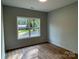 Bedroom featuring wood flooring, window, neutral paint, and plenty of natural light at 305 General As Johnston St, Stanley, NC 28164