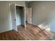 Bedroom featuring wood flooring, neutral paint, closet, and three doors at 305 General As Johnston St, Stanley, NC 28164