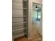 Closet with shelving with view into bedroom featuring ceiling fan, wood floors, and natural light at 305 General As Johnston St, Stanley, NC 28164