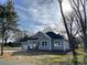 Gray house with white trim, two-car garage, and a large yard at 305 General As Johnston St, Stanley, NC 28164