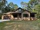 Charming brick home with a well-manicured lawn, covered porch, and attached two-car garage at 305 General As Johnston St, Stanley, NC 28164