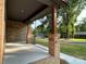 Relaxing front porch view, showcasing sturdy brick pillars and a neatly paved walkway towards nearby homes at 305 General As Johnston St, Stanley, NC 28164