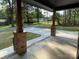 Inviting front porch with brick pillars, offering a glimpse of the serene surroundings and newly paved driveway at 305 General As Johnston St, Stanley, NC 28164