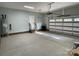 Spacious garage featuring a water heater, electric garage door, and access stairs at 305 General As Johnston St, Stanley, NC 28164