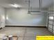 Spacious garage with overhead door and painted walls at 305 General As Johnston St, Stanley, NC 28164