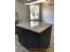 Modern kitchen island with granite countertop and dark-colored cabinets at 305 General As Johnston St, Stanley, NC 28164