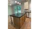 Kitchen island featuring dark countertop, wood cabinets, and open access at 305 General As Johnston St, Stanley, NC 28164