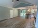 Open-concept living area leading to a modern kitchen and a sliding glass door with backyard view, complete with hard floors at 305 General As Johnston St, Stanley, NC 28164