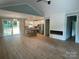 Open-concept living room flowing to the kitchen, featuring a modern fireplace and ample natural light at 305 General As Johnston St, Stanley, NC 28164