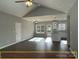 Open living room and kitchen with hardwood floors and vaulted ceiling at 305 General As Johnston St, Stanley, NC 28164