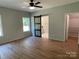 Spacious main bedroom with a ceiling fan and ensuite bathroom access at 305 General As Johnston St, Stanley, NC 28164