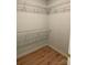 Empty walk-in closet with wire shelving and wood flooring providing ample storage space at 305 General As Johnston St, Stanley, NC 28164
