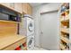 Laundry room with washer, dryer, and shelving at 333 W Trade St # 1204, Charlotte, NC 28202