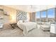 Spacious main bedroom with large window, city views, and stylish headboard at 333 W Trade St # 1204, Charlotte, NC 28202